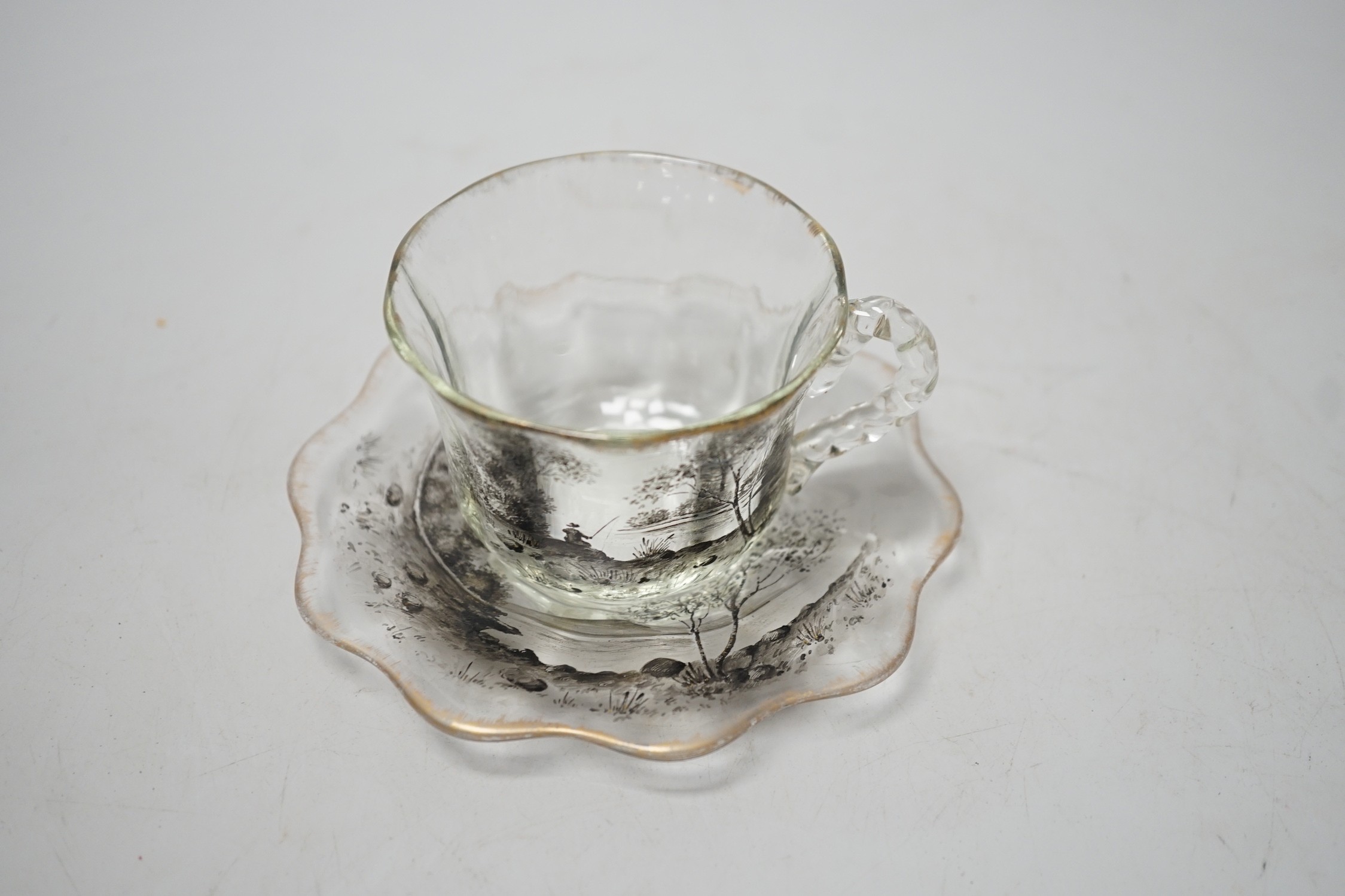 An unusual Emile Galle enamelled miniature glass cup and saucer. 6cm tall